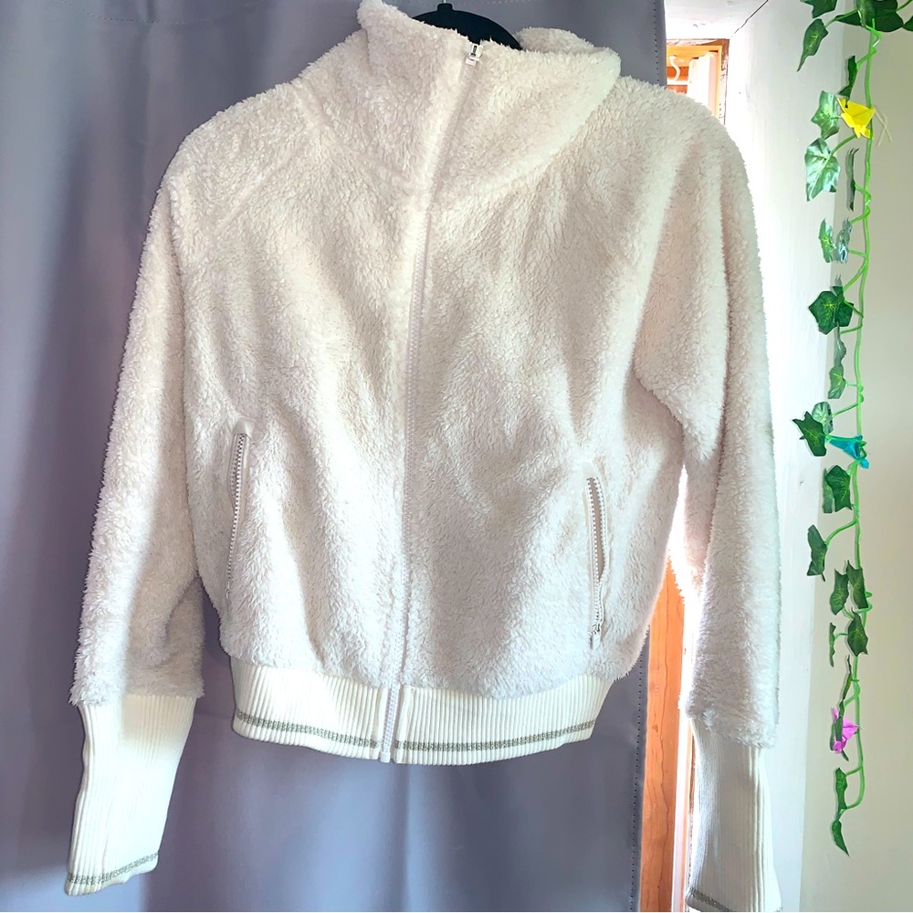 Zip up hoodie. Brand is Athleta. Size: xtra small. The color is off-white.